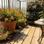 A sun-drenched apartment balcony filled with potted drought-tolerant flowers under a bright, hot summer sun.
